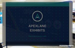 Straight tension fabric display back wall with Apexlane Exhibits invent branding, drum-taut pillowcase on aluminum tube frame in an indoor booth warehouse scene